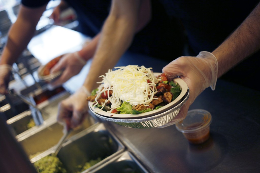 An employee prepares a burrito bowl at a Chipotle Mexican Grill Inc. restaurant. in Louisville, Kentucky, USA, on Saturday, February 2, 2019. 